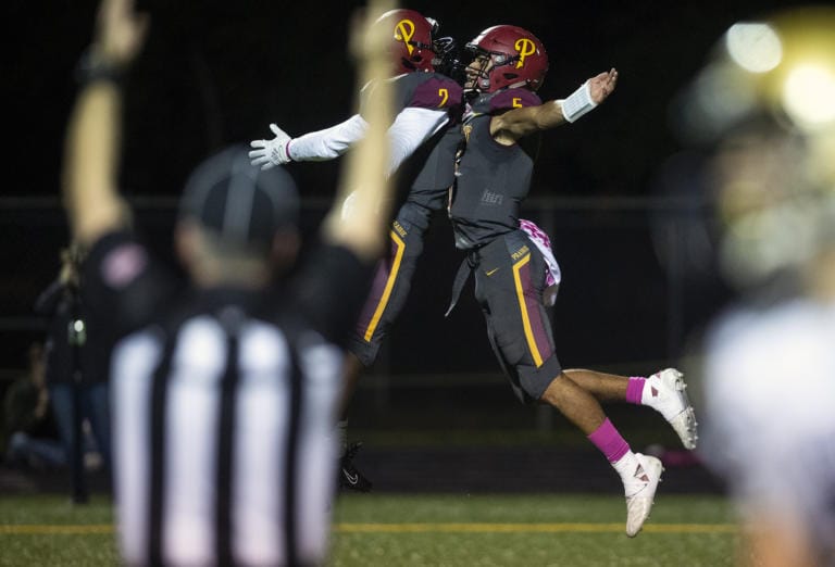 Prairie's Jimmie Barton (2) and A.J. Dixson (5) celebrate a touchdown during Friday night's game at District Stadium in Battle Ground on Oct. 4, 2019. Prairie won 38-22.