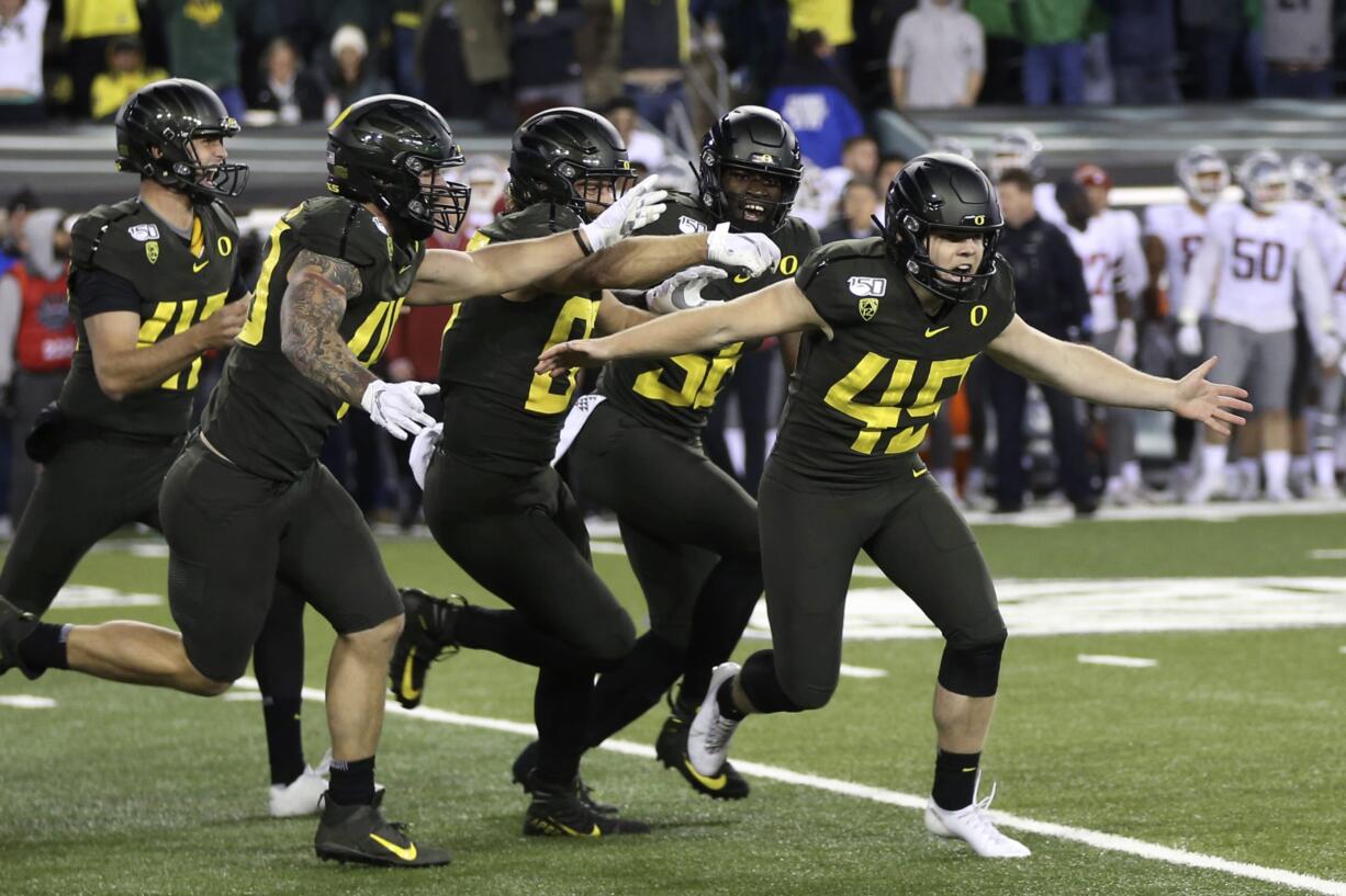 Oregon kicker Camden Lewis, right, begins the celebration after his game winning field goal against Washington State in an NCAA college football game Saturday, Oct. 26, 2019, in Eugene, Ore.