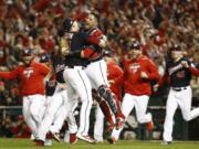 Washington Nationals&#039; Yan Gomes and Daniel Hudson celebrate after Game 4 of the baseball National League Championship Series Tuesday, Oct. 15, 2019, in Washington. The Nationals won 7-4 to win the series 4-0.