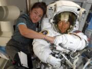 FILE - In this image released Friday, Oct. 4, 2019, by NASA, astronauts Christina Koch, right, and, Jessica Meir pose for a photo on the International Space Station. NASA has moved up the first all-female spacewalk to Thursday, Oct. 17, 2019, or Friday because of a power system failure at the International Space Station.