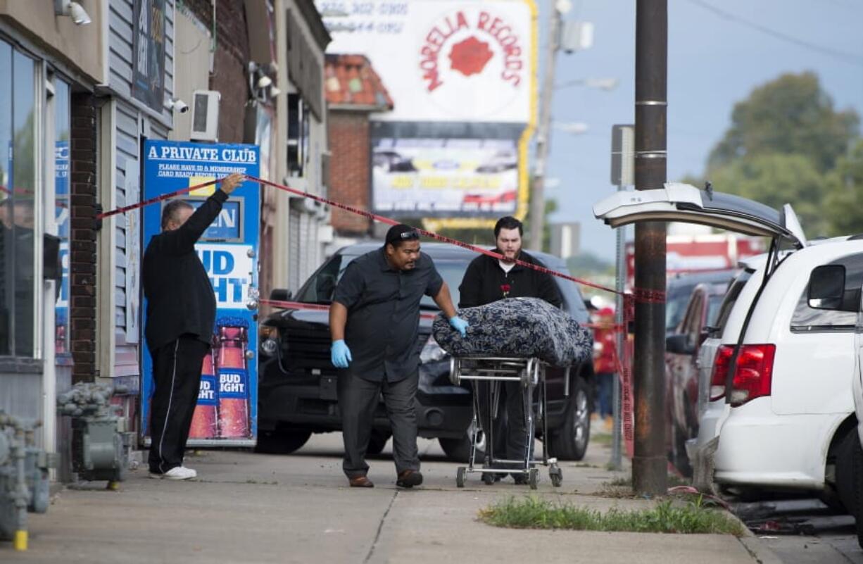 One of multiple shooting victims is loaded into a coroner&#039;s van Sunday following a shooting at Tequila KC Bar in Kansas City, Kan.