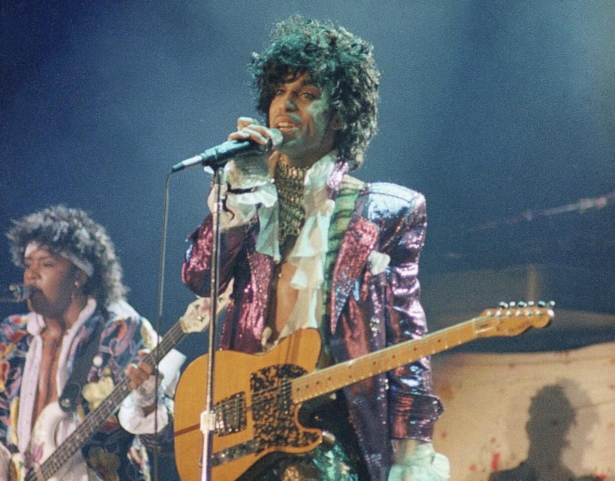 FILE - In this 1985 file photo, singer Prince performs in concert. The Revolution, the band that helped catapult Prince to international superstardom is reuniting in his memory. &quot;Prince: The Beautiful Ones,&quot; the memoir Prince started but didn&#039;t finish before his 2016 death, will be released  on Tuesday, Oct. 29, 2019.