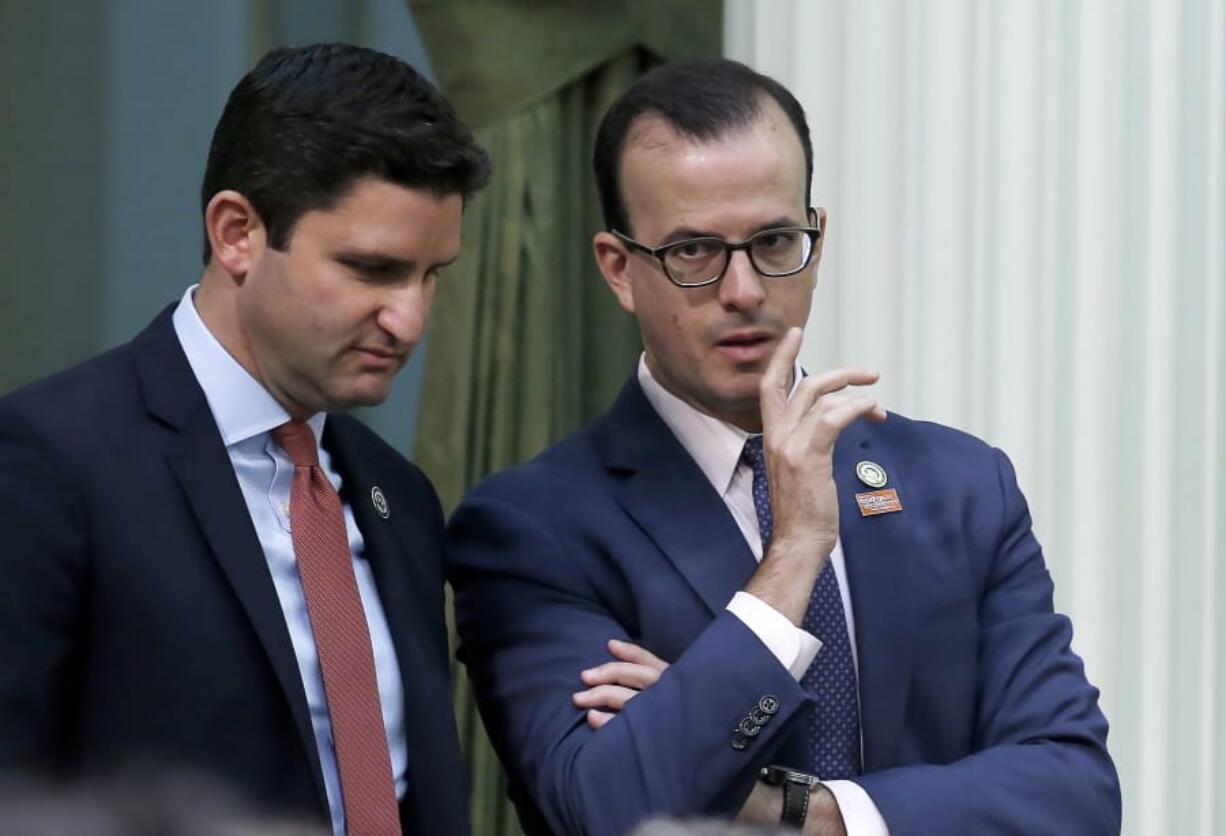 FILE -  In this Sept. 10, 2019 file photo, Assemblyman Marc Berman, D-Palo Alto, right, talks with Assemblyman Jesse Gabriel, D-Encino, left, at the Capitol in Sacramento, Calif. Gov. Gavin Newsom announced Thursday Oct. 3, 2019, that he signed Berman&#039;s measure banning so-called &quot;deep fake&quot; videos designed to manipulate a political candidate&#039;s words or actions in the lead up to elections, It&#039;s a response to fears of dirty campaigning during the upcoming presidential race, but also a proposal that raises concerns about censorship and the First Amendment.