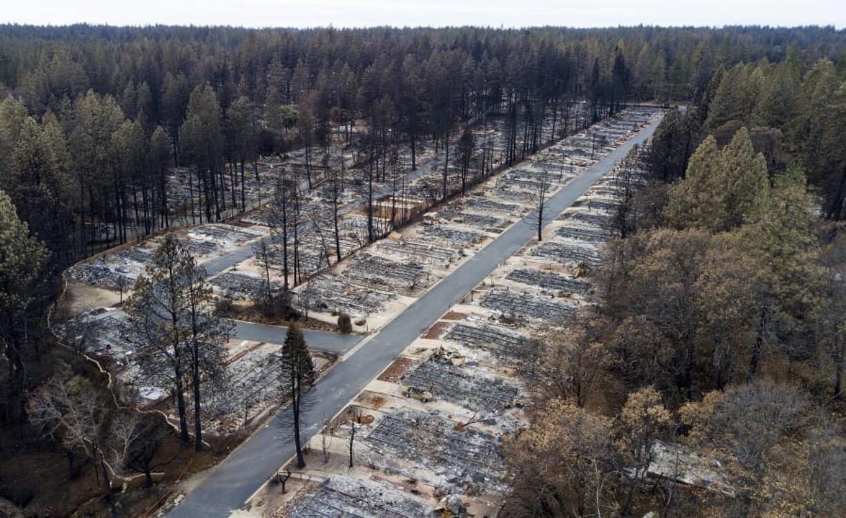 FILE - In this Dec. 3, 2018, file photo, homes leveled by the Camp Fire line the Ridgewood Mobile Home Park retirement community in Paradise, Calif. Attorneys say as many as 100,000 Californians are eligible to receive payments for the damages they&#039;ve suffered from a series of devastating wildfires over the last several years, but tens of thousands of them have not. They face a Monday, Oct. 21, 2019, deadline to file claims against Pacific Gas &amp; Electric, the utility blamed for many of the fires.