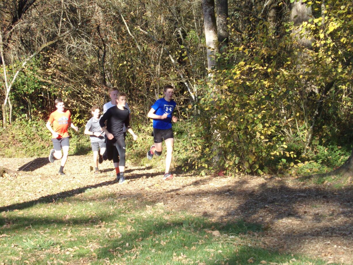 Members of the Cedar Tree Classical Christian boys cross country team run a workout on trails around the north Clark County campus (Tim Martinez/The Columbian)