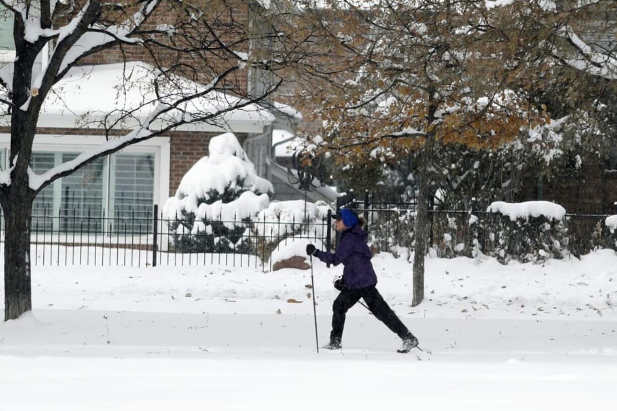 A cross-country skier moves through Washington Park as an autumn snowstorm sweeps over the intermountain West, Tuesday, Oct. 29, 2019, in Denver. Forecasters predict that this second storm in two days will bring up to a foot of snow in some places in the region as well as pack an intense cold that may drop temperatures to possibly record-setting lows.