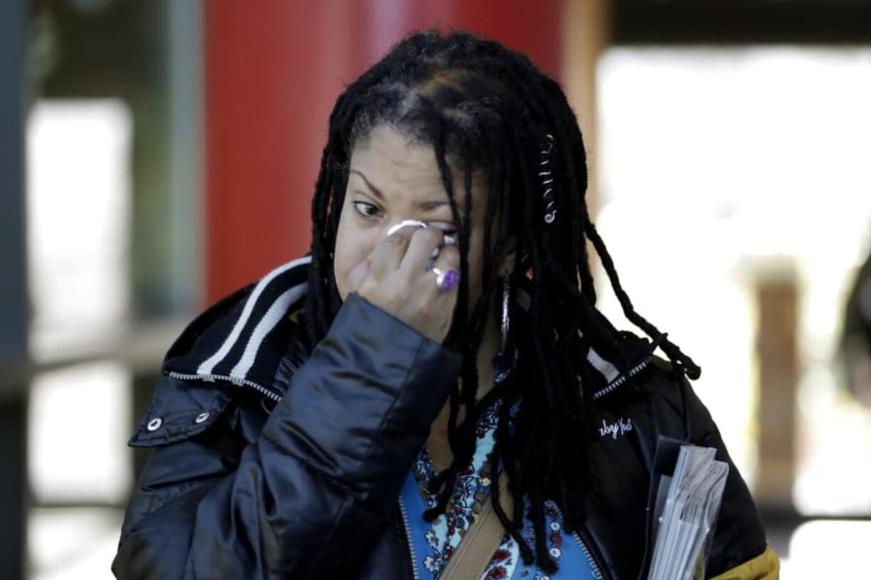 Katrina Hutton wipes tears as she leaves Gilliam Concert Hall after viewing the open casket of U.S. Rep. Elijah Cummings at Morgan State University, Wednesday, Oct. 23, 2019, in Baltimore.