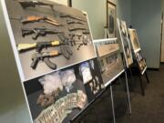 Photos of guns, drugs, and money are displayed at a news conference, Wednesday, Oct. 2, 2019, in Portland, Ore. U.S. Attorney Billy Williams said Wednesday that Federal authorities in Oregon had completed one of the largest drug trafficking busts in state history that involved a vast international network of couriers, dealers and stash-house operators who smuggled methamphetamine, heroin and cocaine worth about $15 million from Mexico to Portland.