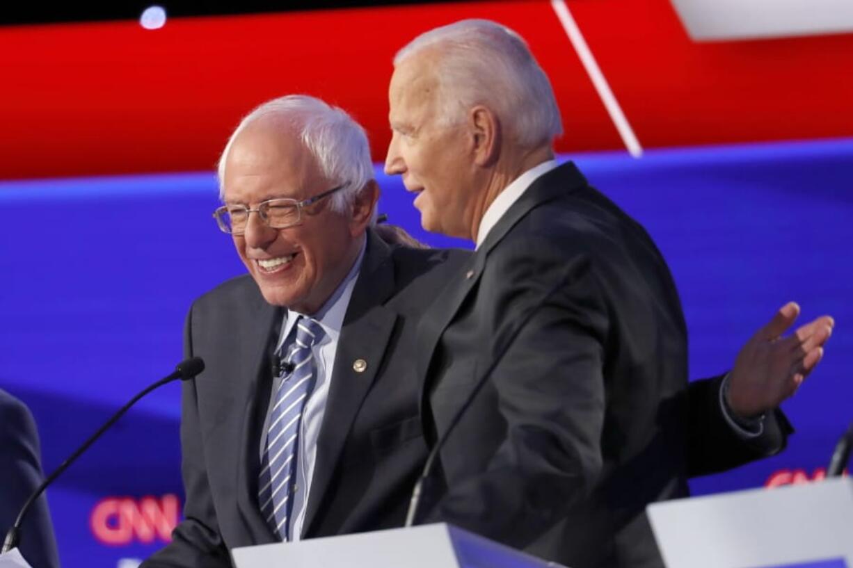 Democratic presidential candidate Sen. Bernie Sanders, I-Vt., left, and former Vice President Joe Biden hug during a Democratic presidential primary debate hosted by CNN/New York Times at Otterbein University, Tuesday, Oct. 15, 2019, in Westerville, Ohio.