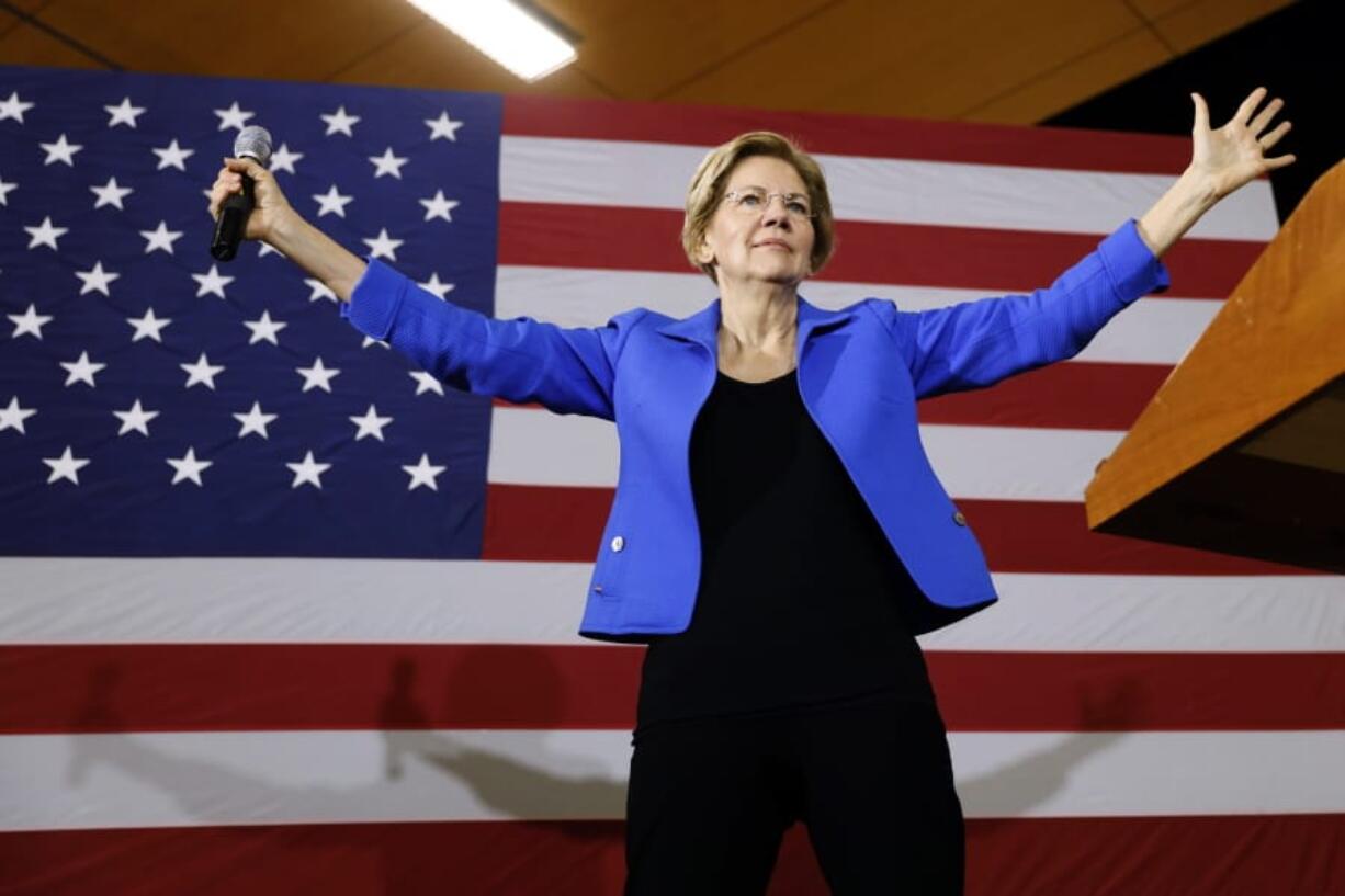 FILE - In this Oct. 21, 2019, photo, Democratic presidential candidate Sen. Elizabeth Warren, D-Mass., speaks to students and staff at Roosevelt High School in Des Moines, Iowa. For Warren, it was supposed to be another big idea in a campaign full of them:  A promise that everyone could get government-funded health care, following the lead of her friend and fellow White House hopeful Bernie Sanders.