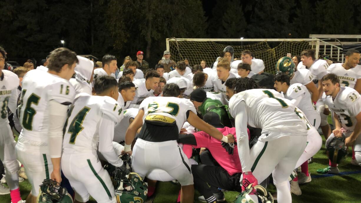 Evergreen players crouch down during a cheer after a 42-14 win over Hudson's Bay on Friday at Kiggins Bowl.