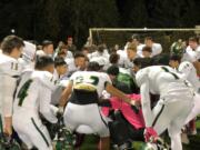 Evergreen players crouch down during a cheer after a 42-14 win over Hudson's Bay on Friday at Kiggins Bowl.