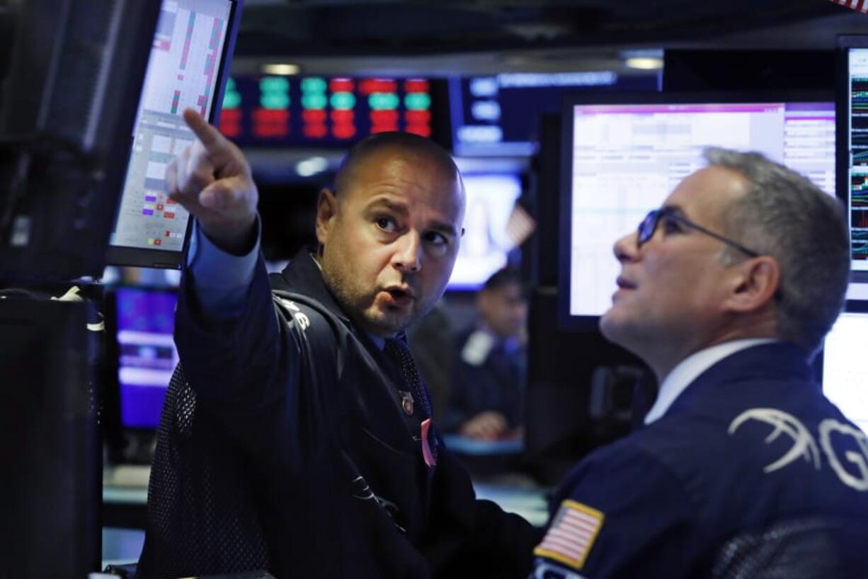 Specialists Mario Picone, left, and Anthony Rinaldi work on the floor of the New York Stock Exchange, Monday, Oct. 7, 2019. Stocks are opening broadly lower on Wall Street, extending the market&#039;s losing streak into a fourth week.