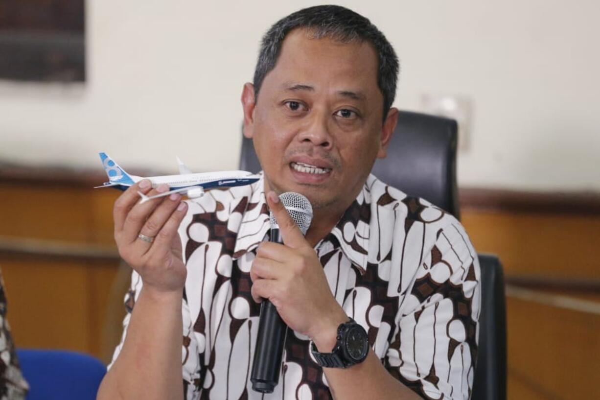 National Transportation Safety Committee investigator Nurcahyo Utomo holds a model of an airplane during a press conference in Jakarta, Indonesia, Friday, Oct. 25, 2019. An Indonesian investigation found a Lion Air flight that crashed and killed 189 people a year ago was doomed by a combination of aircraft design flaws, inadequate training and maintenance problems.