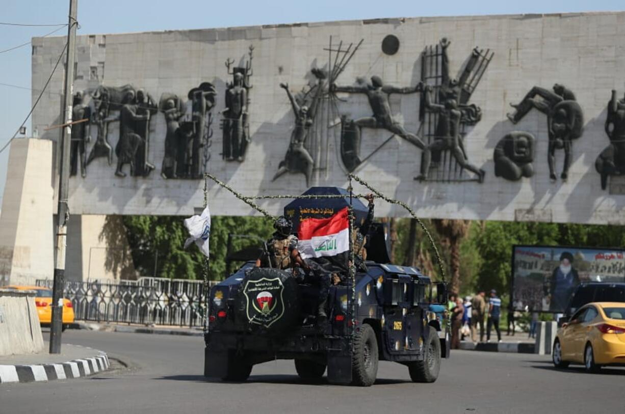 Iraqi security forces arrive near the site of the protests in Tahrir square, central Baghdad, Iraq, Saturday, Oct. 5, 2019. Curfew has been lifted Saturday in the Iraqi capital, days after authorities imposed it in an attempt to quell anti-government demonstrations that have turned deadly. Officials say at least 64 were killed in the four-day protests that have rocked the capital and southern cities.