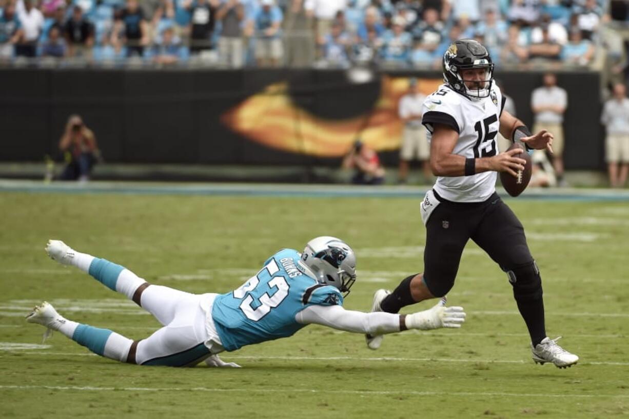 Carolina Panthers linebacker Brian Burns (53) dives for Jacksonville Jaguars quarterback Gardner Minshew (15) during the second half of an NFL football game in Charlotte, N.C., Sunday, Oct. 6, 2019.