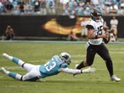 Carolina Panthers linebacker Brian Burns (53) dives for Jacksonville Jaguars quarterback Gardner Minshew (15) during the second half of an NFL football game in Charlotte, N.C., Sunday, Oct. 6, 2019.