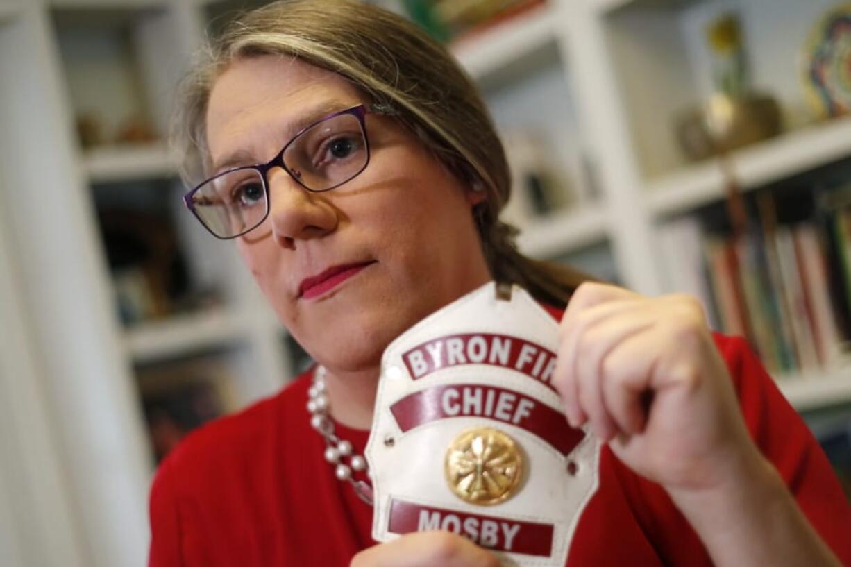 In this Sept. 26, 2019, photo, former Byron, Ga., fire chief Rachel Mosby poses for a photo in the home of a friend in Atlanta. Mosby is a transgender woman who held the job for more than a decade as a man, then was fired in June, 18 months after she openly transitioned.