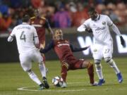 Portland Timbers defender Jorge Villafana (4) pressures Real Salt Lake midfielder Everton Luiz (25) with help from forward Dairon Asprilla (27) aduring the first half of an MLS soccer Western Conference first-round playoff match in Sandy, Utah, Saturday, Oct. 19, 2019.