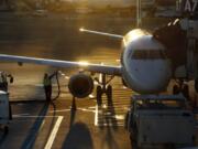 FILE - In this Dec. 8, 2018, file photo a worker fuels a Delta Connection regional airlines passenger jet at Logan International Airport in Boston. More than 7 in 10 U.S. airline passengers (72%) say ticket price is a key deciding factor when choosing an airport to fly into or from, according to a 2019 survey commissioned by NerdWallet and conducted online by The Harris Poll among more than 1,800 U.S. adults who have ever flown on an airplane.