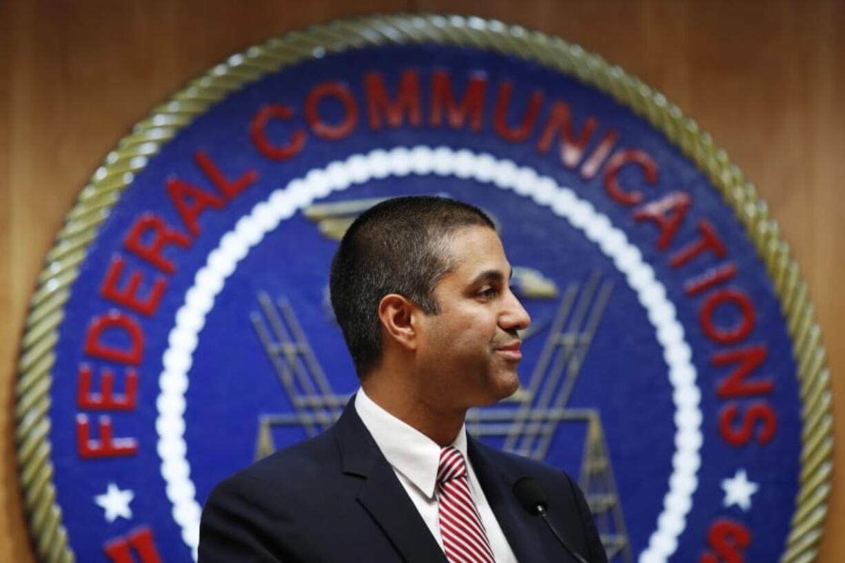 After a meeting voting to end net neutrality, Federal Communications Commission Chairman Ajit Pai smiles while listening to a question from a reporter on Dec. 14, 2017, in Washington.