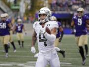 Oregon&#039;s Mycah Pittman leaves Washington defenders behind as he runs after a pass reception for a 36-yard touchdown in the second half of an NCAA college football game Saturday, Oct. 19, 2019, in Seattle. Oregon won 35-31.