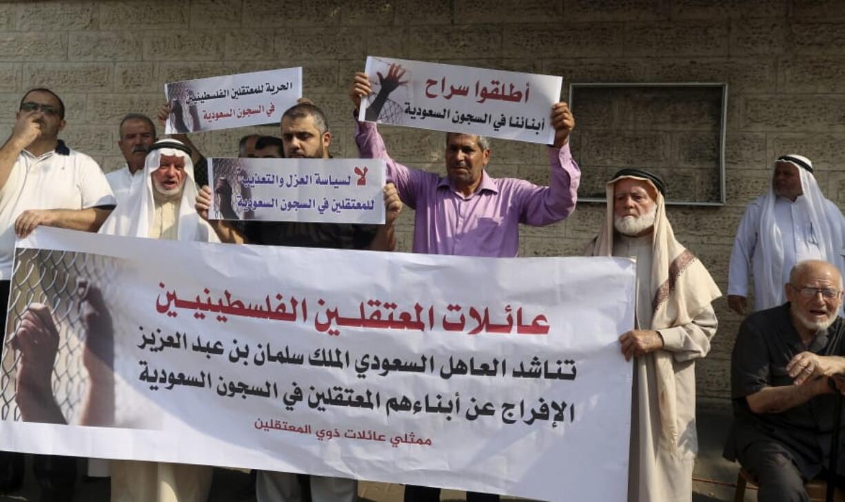 Families of Palestinians held in jails in Saudi Arabia, hold placards in Arabic that some read, &quot;Release our sons in Saudi prisons, and No for the policy of isolation and torture for the prisoners in Saudi jails&quot; during a protest, in front of the International Committee of the Red Cross office, in Gaza, Wednesday, Oct. 16, 2019.