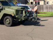 Police SWAT vehicles leave a Hazel Dell neighborhood after a 37-year-old man was arrested on suspicion of second-degree assault after a three-hour standoff.