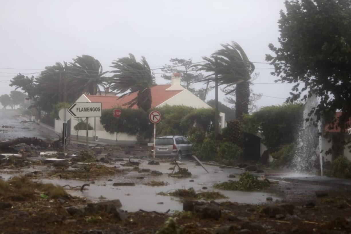 Debris blocks a road Wednesday in the seafront village of Feteira on the Portuguese island of Faial.