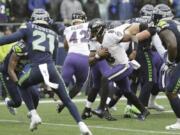 Baltimore Ravens quarterback Lamar Jackson (8) keeps the ball for a touchdown on a fourth-down play against the Seattle Seahawks during the second half of an NFL football game, Sunday, Oct. 20, 2019, in Seattle.