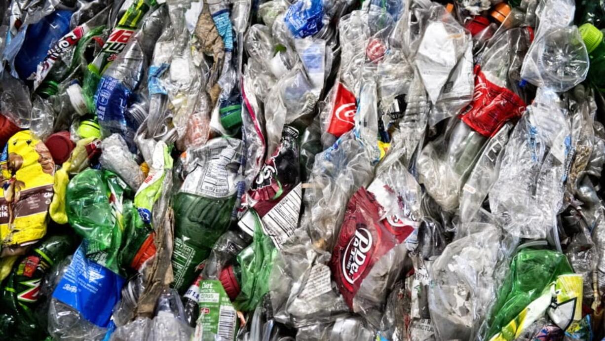 Crushed plastic bottles sit in a bale following sorting at the Mid-America Recycling plant in Lincoln, Neb.