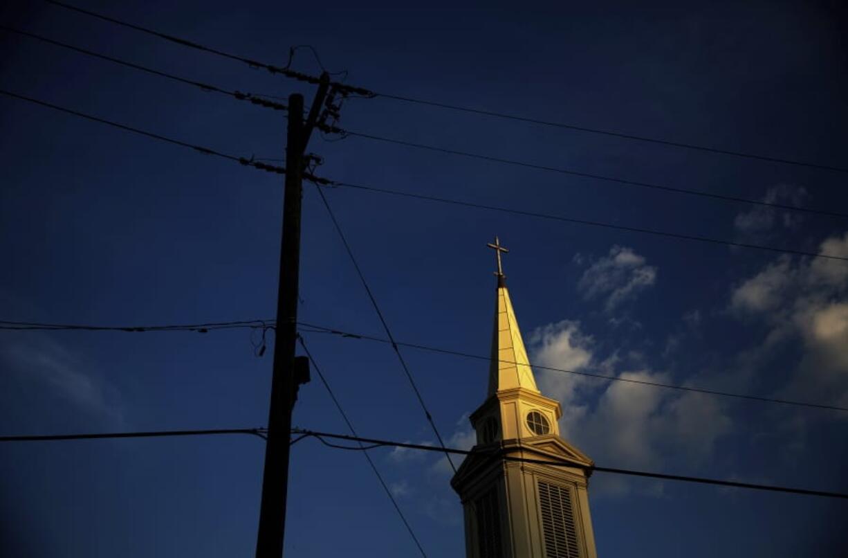 FILE - In this Tuesday, April 11, 2017 file photo, the sun sets on a Baptist church in Georgia. According to new data released Thursday, Oct. 17, 2019, by the Pew Research Center, the portion of Americans with no religious affiliation is rising significantly, in tandem with a sharp drop in the percentage that identifies as Christian.