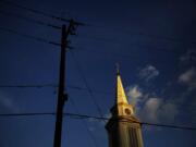 FILE - In this Tuesday, April 11, 2017 file photo, the sun sets on a Baptist church in Georgia. According to new data released Thursday, Oct. 17, 2019, by the Pew Research Center, the portion of Americans with no religious affiliation is rising significantly, in tandem with a sharp drop in the percentage that identifies as Christian.