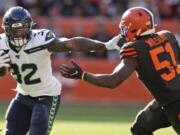 Seattle Seahawks running back Chris Carson (32) rushes against Cleveland Browns linebacker Mack Wilson (51) during the second half of an NFL football game, Sunday, Oct. 13, 2019, in Cleveland.