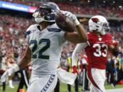 Seattle Seahawks running back C.J. Prosise (22) scores a touchdown against the Arizona Cardinals during the second half of an NFL football game, Sunday, Sept. 29, 2019, in Glendale, Ariz. (AP Photo/Ross D.