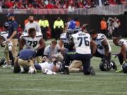 Seattle Seahawks center Justin Britt (68) lies injured against the Atlanta Falcons during the first half of an NFL football game, Sunday, Oct. 27, 2019, in Atlanta.