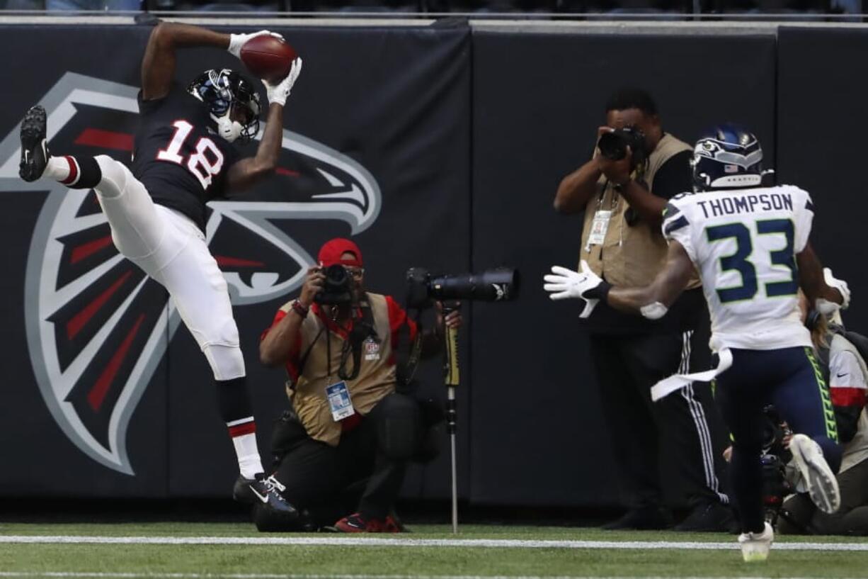 tlanta Falcons wide receiver Calvin Ridley (18) makes the catch for a two-point conversion against Seattle Seahawks free safety Tedric Thompson (33) during the second half of an NFL football game, Sunday, Oct. 27, 2019, in Atlanta.