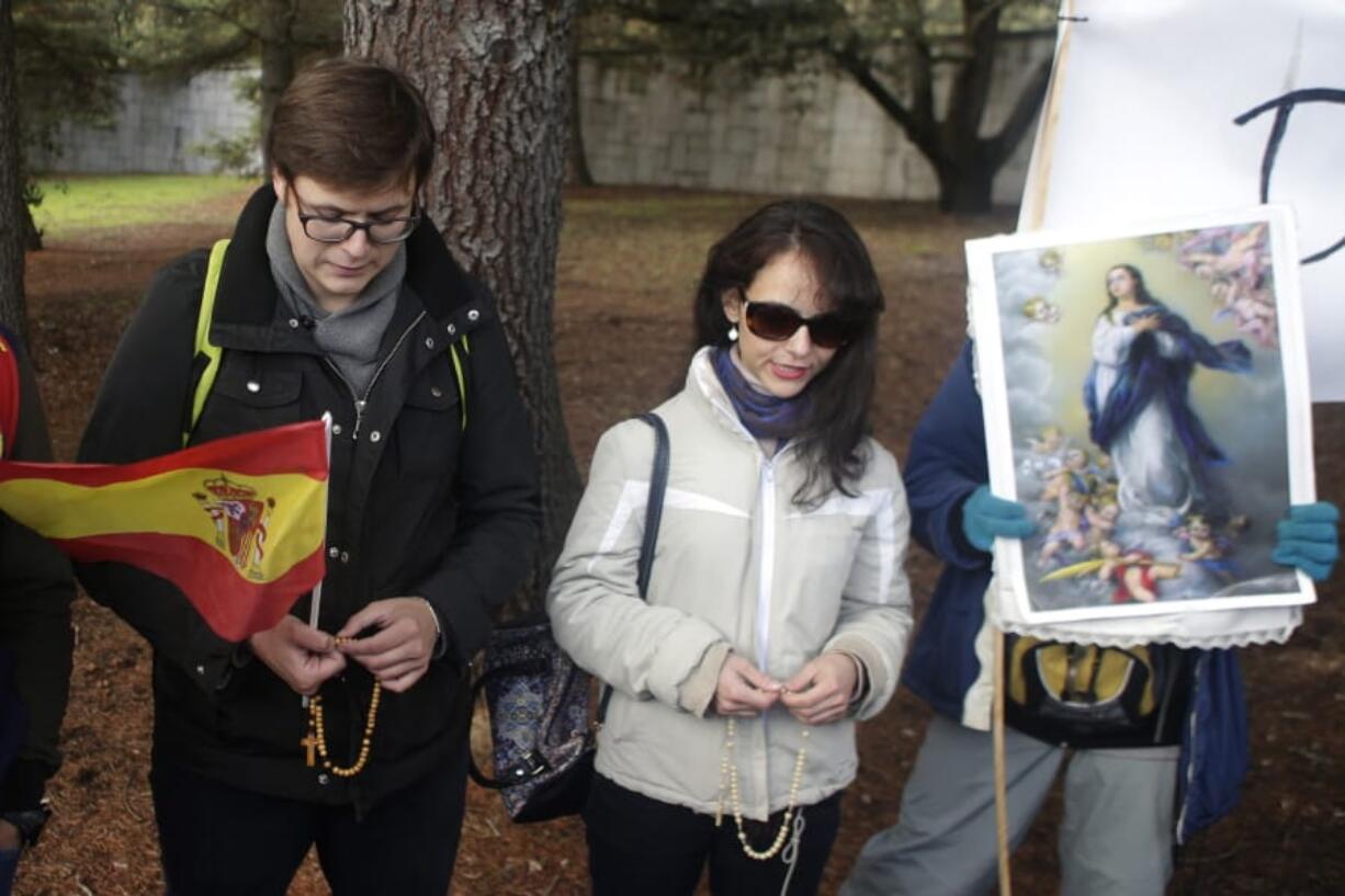 People pray the rosary outside the Fallen mausoleum near El Escorial, outskirts of Madrid, Thursday, Oct. 24, 2019. Forty-four years after his demise, the remains of Spanish dictator Gen. Francisco are to be dug out of his grandiose resting place outside Madrid and taken to a small family crypt, finally satisfying a long-standing demand of his victims&#039; relatives and others who suffered under his regime.