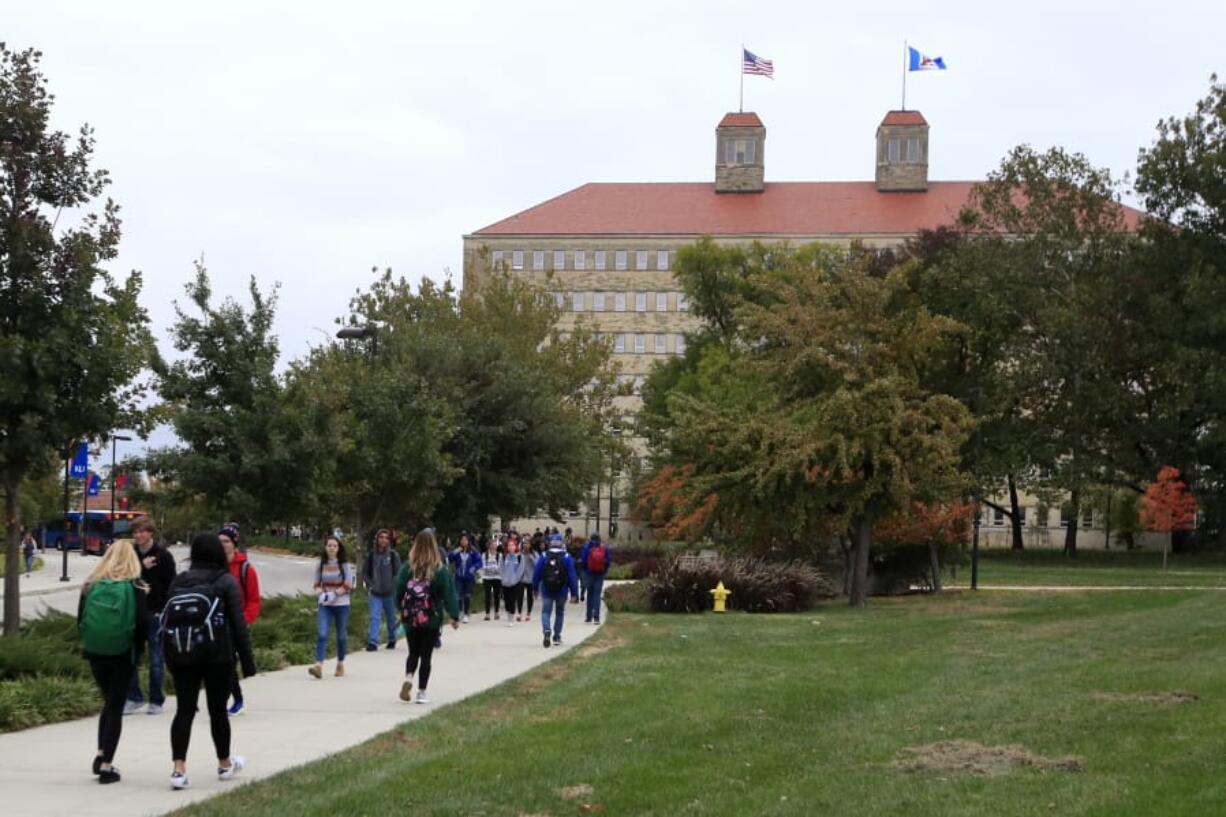 FILE - In this Oct. 24, 2019, file photo students walks in front of Fraser Hall on the University of Kansas campus in Lawrence, Kan. Americans collectively owe nearly $1.5 trillion in student loans, more than twice the total a decade ago. It&#039;s a burden that weighs on millions of adults, shaping their life choices and often stunting their financial growth.