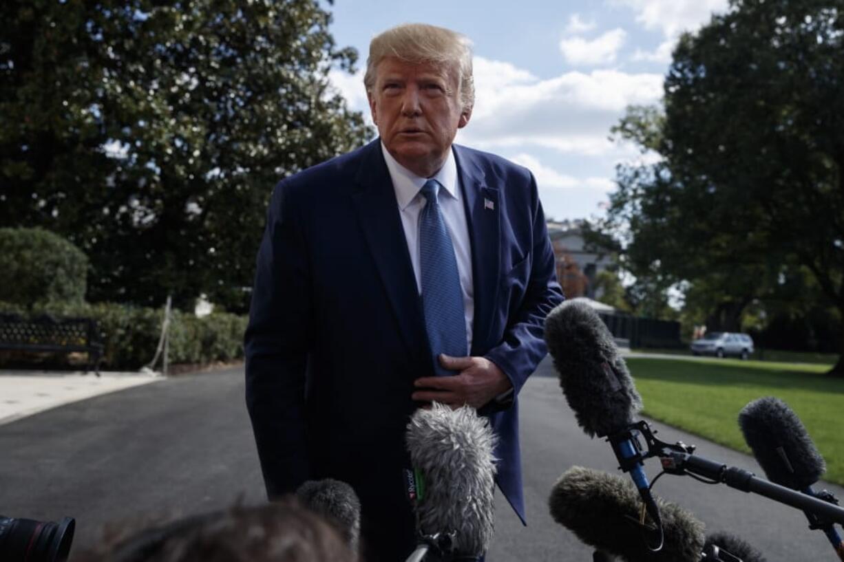 President Donald Trump talks to reporters on the South Lawn of the White House, Friday, Oct. 4, 2019, in Washington.