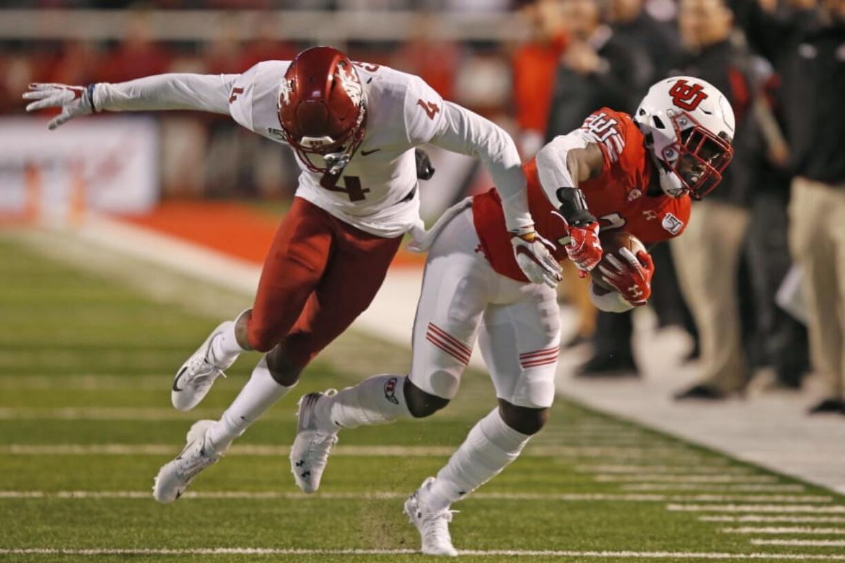 Utah&#039;s Devonta&#039;e Henry-Cole, right, carries the ball as Washington State cornerback Marcus Strong defends on Sept. 28. WSU has allowed 105 points in its last two games.