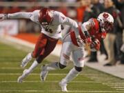 Utah&#039;s Devonta&#039;e Henry-Cole, right, carries the ball as Washington State cornerback Marcus Strong defends on Sept. 28. WSU has allowed 105 points in its last two games.