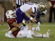 Washington quarterback Jacob Eason is sacked by Stanford&#039;s Scooter Harrington, left, in the second half of an NCAA college football game Saturday, Oct. 5, 2019, in Stanford, Calif.