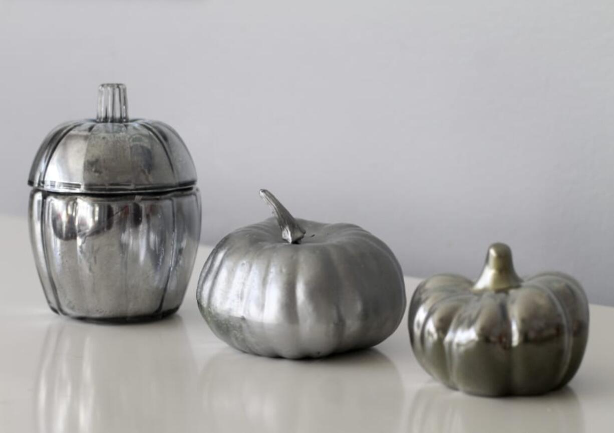 These faux mercury glass pumpkins were created using Krylon Looking Glass spray paint. The version on the left features a glass base, the middle pumpkin is made of foam, and the pumpkin on the right is made of ceramic.