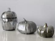 These faux mercury glass pumpkins were created using Krylon Looking Glass spray paint. The version on the left features a glass base, the middle pumpkin is made of foam, and the pumpkin on the right is made of ceramic.