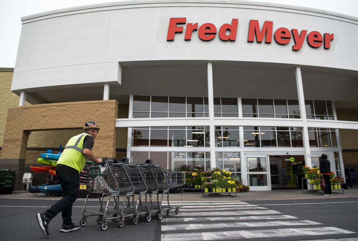 Fred Meyer grocery stores, including the seven in Clark County, on Wednesday began charging customers for getting cash back from its checkout stands.