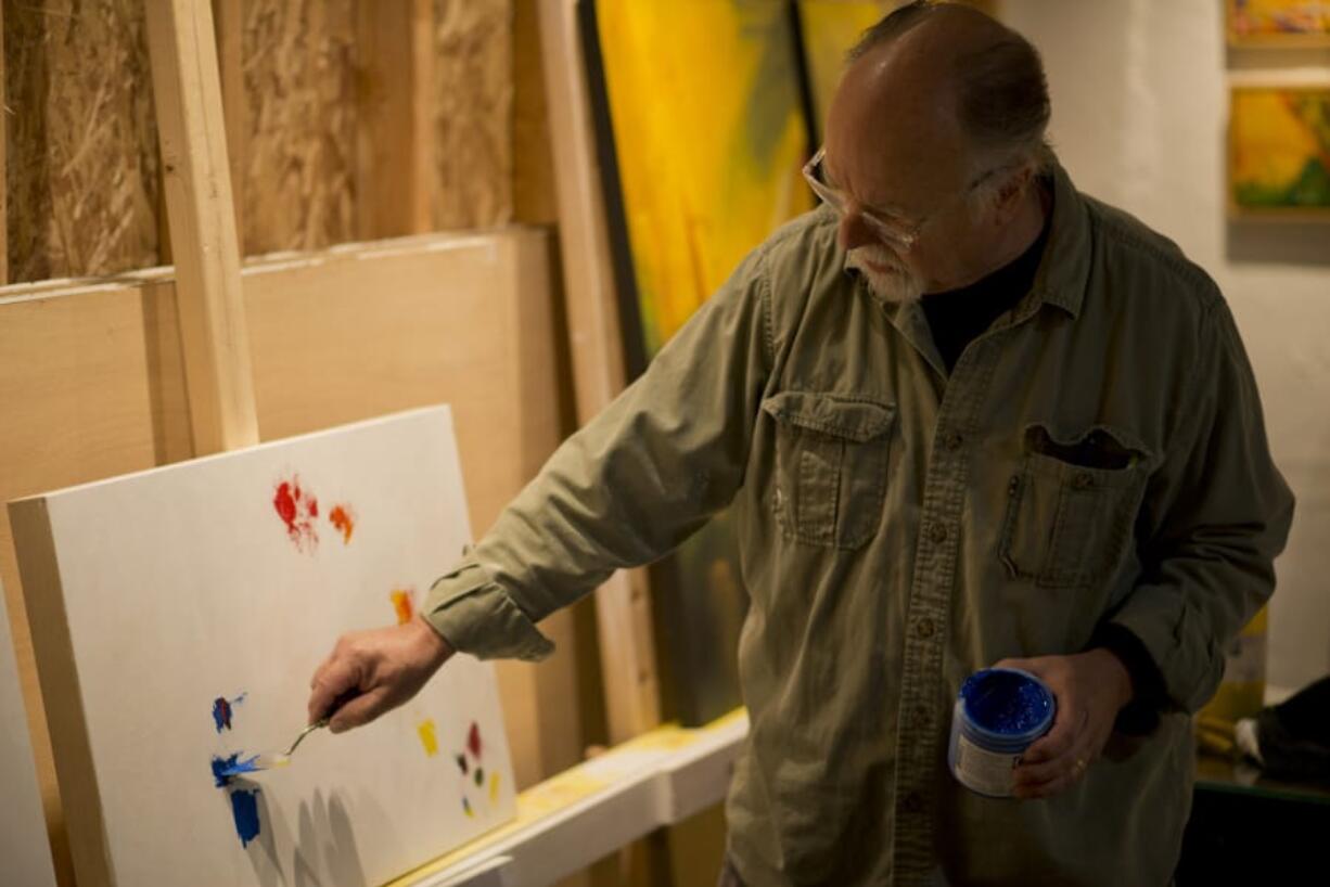 Artist Tom Relth shows visitors his work during the 2018 Clark County Open Studios tour.