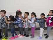 Tobias Adams, 3, fourth from left, joins classmates as they form an orderly line on their way out to recess on Sept. 19 at Minnehaha Early Learning Center. For many of the children just starting preschool, the classroom is the first time they&#039;ve consistently been in a group setting with their peers.