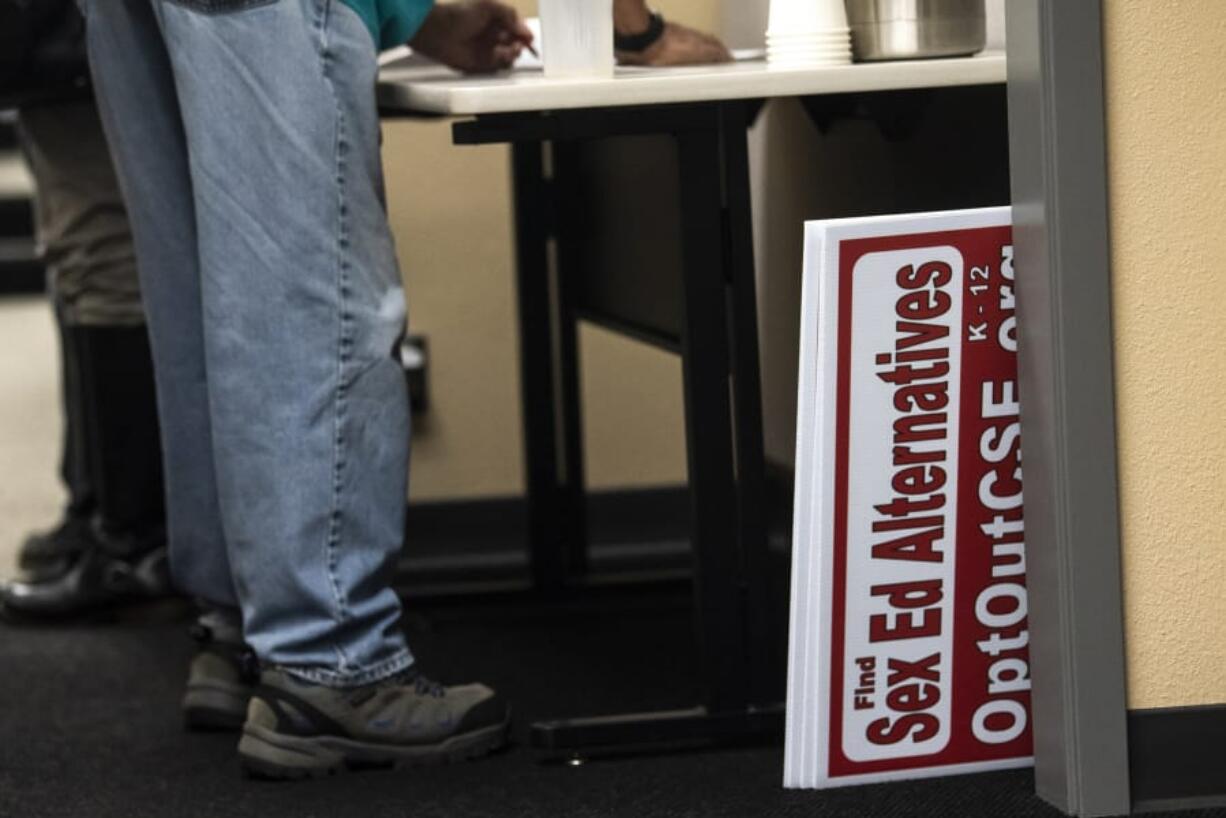 Signs signaling opposition to proposed sex education curriculum are seen after being confiscated from a community member during a Battle Ground Public Schools Board of Directors meeting in October.