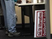 Signs signaling opposition to proposed sex education curriculum are seen after being confiscated from a community member during a Battle Ground Public Schools Board of Directors meeting in October.